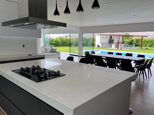 a kitchen with a stove top island in a room at Casa de Campo VIP San Andrés in San Andrés