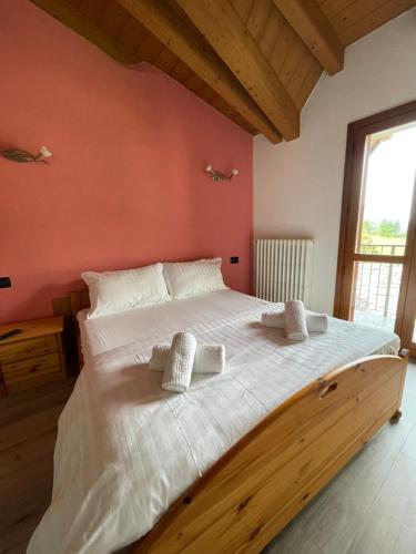a bedroom with a large bed with two pillows on it at Orobie Holiday Apartments in Albosaggia