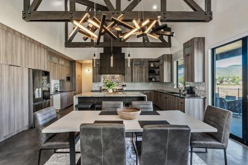 a kitchen with a table and chairs and a kitchen with a view at Hot Tub Minutes 2 ParkCity & Jodanelle Pets are Allowed in Francis