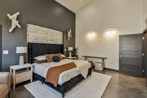 a bedroom with a large bed and a couch at Hot Tub Minutes 2 ParkCity & Jodanelle Pets are Allowed in Francis