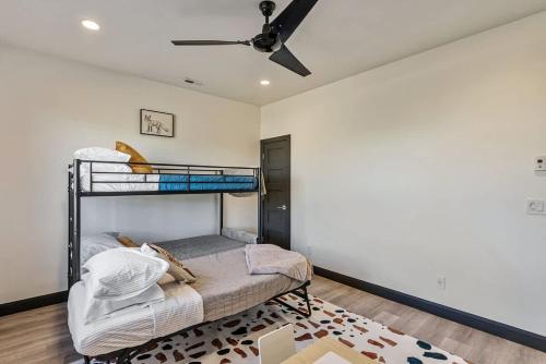 a bedroom with a bunk bed and a ceiling fan at Hot Tub Minutes 2 ParkCity & Jodanelle Pets are Allowed in Francis