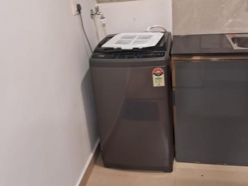 a black stove in a kitchen next to a counter at Seashells Pentagon Calicutbeach in Kozhikode