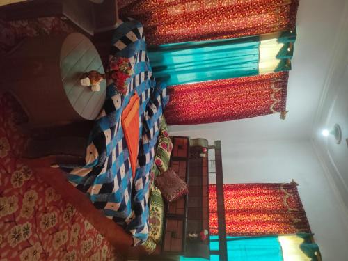 a room with a bed with a mirror and a curtain at Kashmir naaz in Srinagar