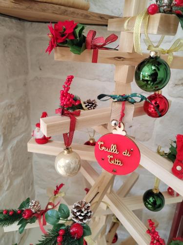 a wooden ladder with christmas ornaments on it at Trulli di Titti - Luxury Country House in Castellana Grotte