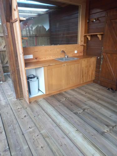 a kitchen with a sink in a cabin at CHALET B NATURISTe MAEVA in Le Porge