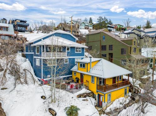 a group of houses on a hill in the snow at Walk to Main St, Luxurious Family Home, 3 BR, Amazing Deck with Private Hot Tub and Downtown Views in Park City