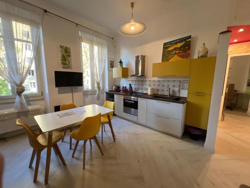 a kitchen with a table and a table and chairs at Maison Trionfale a 2 passi dal Vaticano in Rome