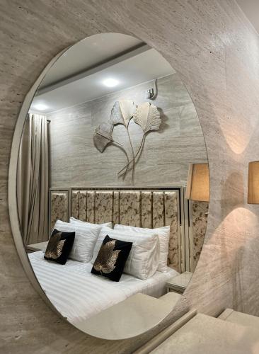 a bedroom with a large circular mirror over a bed at Kings Den 1BHK in Rawalpindi