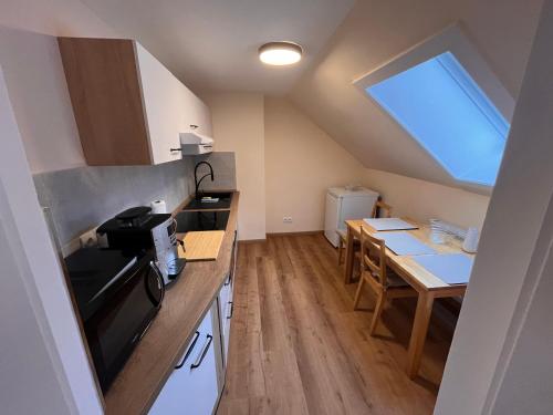 a small kitchen with a table and a window at Casper-David-Friedrich in Königstein an der Elbe
