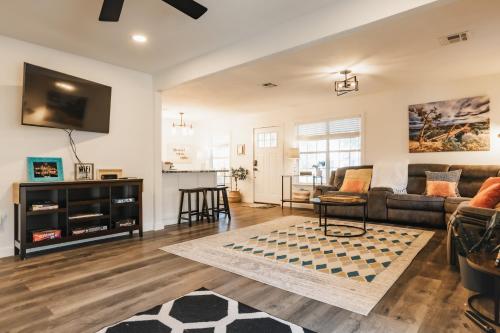 a living room with a couch and a table at Longhorn Pool Home with King Bed & Rain Showers Walk to DT & Lake in Austin