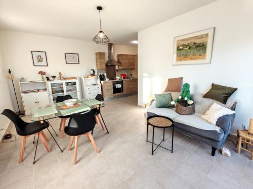 un salon avec un canapé et une table dans l'établissement Les deux Oliviers, à Roussillon