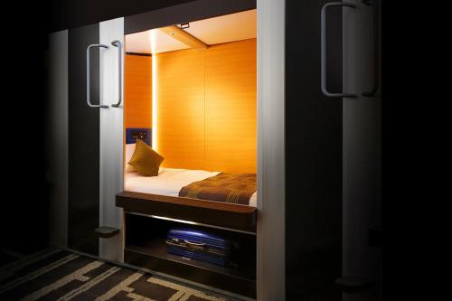 a small bedroom with a bed in a small room at MyCUBE by MYSTAYS Asakusa Kuramae in Tokyo