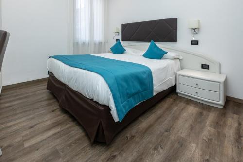 Postel nebo postele na pokoji v ubytování Albergo Cappello e Cadore
