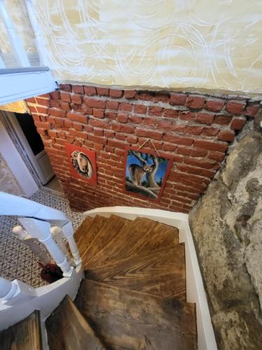 an overhead view of a brick wall with paintings on it at Gizli Bahçe Pansiyon in Seferihisar