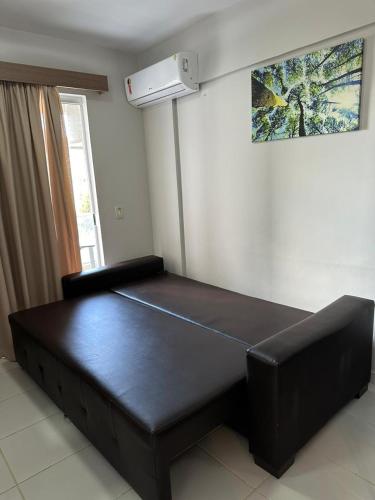 a large black bed in a room with a ceiling at Flats - Veredas do Rio Quente in Rio Quente