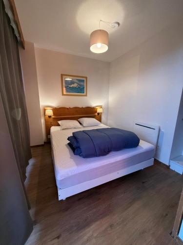 une chambre avec un grand lit dans une pièce dans l'établissement Le Cocon 4 Saisons - Les Villages du Bachat à Chamrousse 1700 - Droseras A14 - Classé 3 étoiles, à Chamrousse