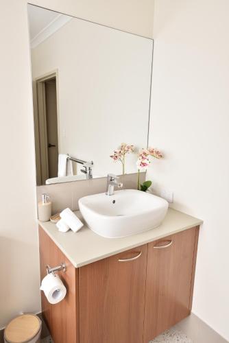 a bathroom with a sink and a mirror at Nelum managed by Sahas Homes in Dunsborough