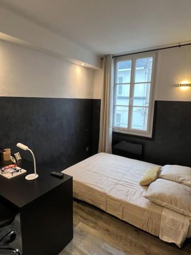 une chambre avec un lit, un bureau et une fenêtre dans l'établissement Échec et Mat chic - Gare & Hyper Centre, à Angers