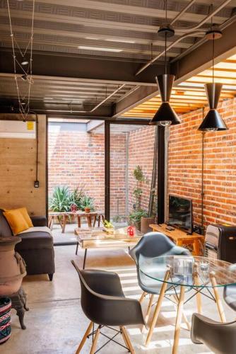 a living room with chairs and a table at Casa Franco - Modern Architecture Home with AC in San Miguel de Allende