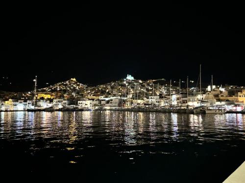 a view of a city from the water at night at House by the beach,next to village,sunset view in Finikas