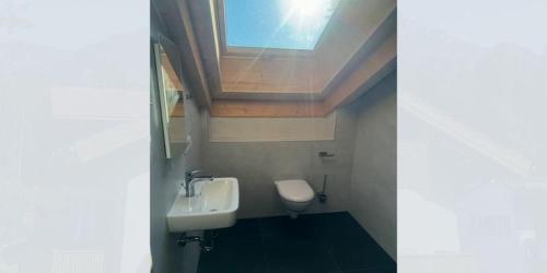 a bathroom with a sink and a toilet at Alpenchalets Zugspitze in Grainau