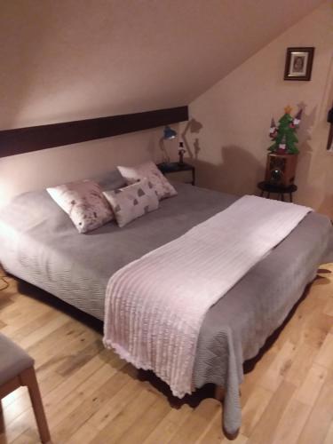 a bedroom with a large bed with white sheets and pillows at Ferme du Mouton Noir in Lautenbachzell