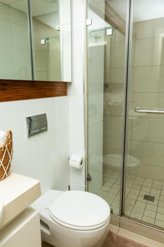 a bathroom with a toilet and a shower at Zimbali Suites 320 in Ballito