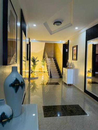 a living room with a vase on a table at Les HOTELS TALHAYA, NOUAKCHOTT in Nouakchott
