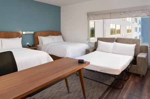 a hotel room with two beds and a table at Element by Westin Orlando International Drive in Orlando