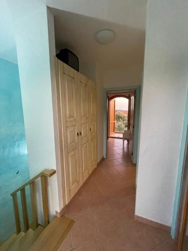 a hallway of a house with a door and a staircase at Casa delle Farfalle in Chia