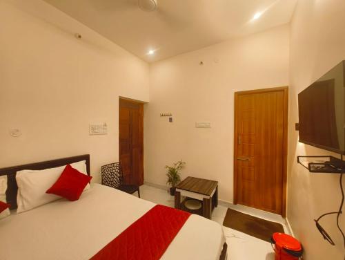 a bedroom with a bed and a flat screen tv at Rudra Elite in Rāmeswaram
