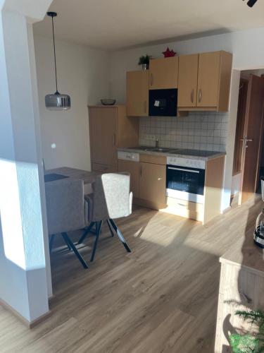 a kitchen with a table and chairs in a room at Appartement Heiss in Kleinarl