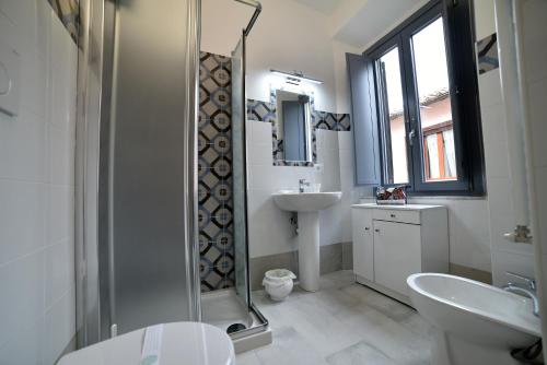 a bathroom with a shower and a sink and a toilet at Il Palazzetto in Bolsena