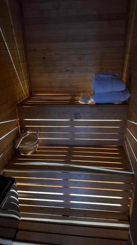 a bench in a sauna with a blue bag on it at Stone Chalets - TERRA in Jajce