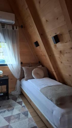 a bedroom with a bed in the attic at Stone Chalets - TERRA in Jajce