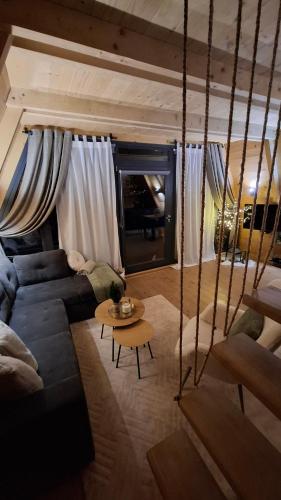 a living room with a couch and a table at Stone Chalets - TERRA in Jajce