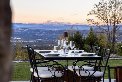 a table with wine glasses on it with a view at Štok - Rooms, Wine & Restaurant - Marezige, Koper in Koper