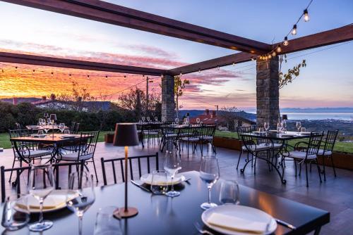 a patio with tables and chairs with a view at Štok - Rooms, Wine & Restaurant - Marezige, Koper in Koper