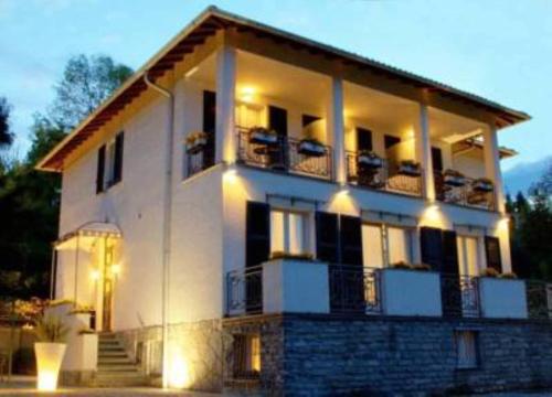 a large white building with lights in front of it at Miralago B&B and Apartments in Bellagio