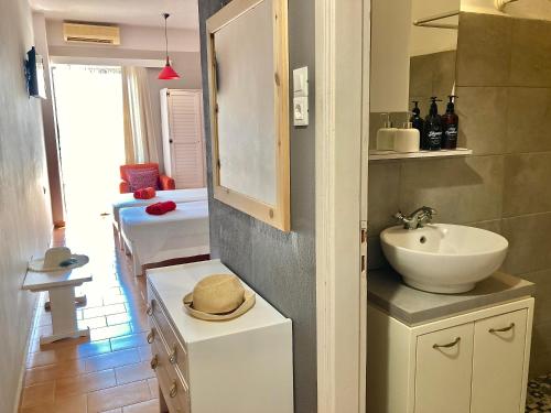 a bathroom with a sink and a mirror and a sink at Eleana Apartments in Hersonissos