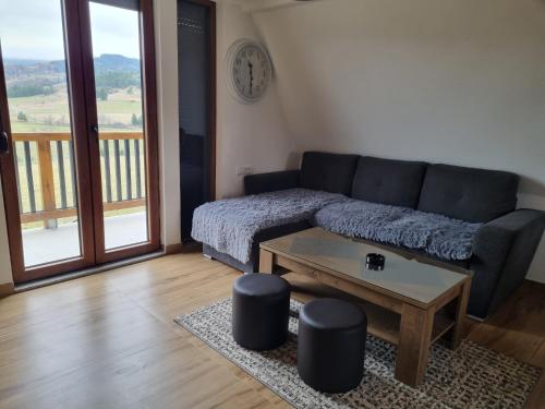a living room with a couch and a coffee table at Kutak Maša in Rudno