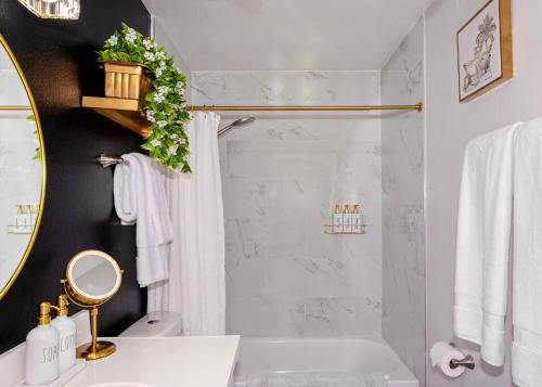 a bathroom with a shower and a sink and a mirror at Villa Golden - King Bed & Swimming Pool! in Tempe