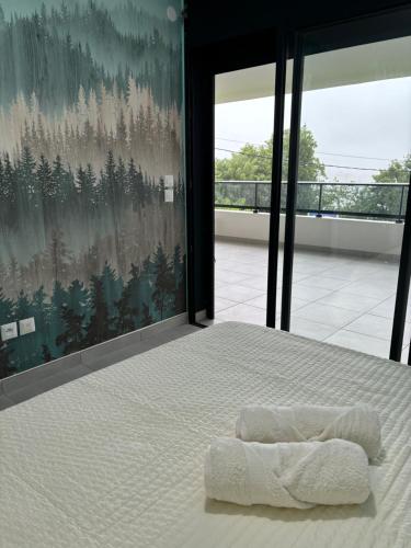 a bedroom with a bed with a blanket on it at Very nice view of the caribbean sea in Schœlcher