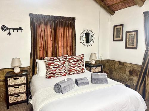 a bedroom with a bed with towels on it at Echo Valley Guest Farm in Breyten
