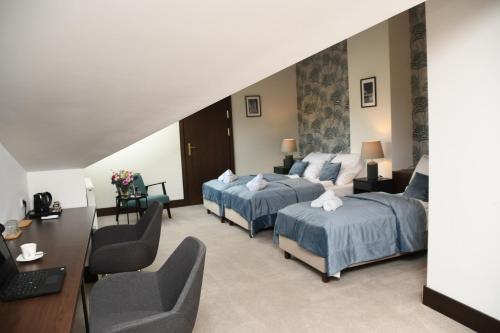 a hotel room with two beds and a desk at MedHotel Smart Krupnicza w Krakowie in Kraków