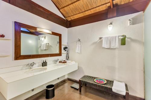 a bathroom with a sink and a mirror at Aamby Valley City in Lonavala