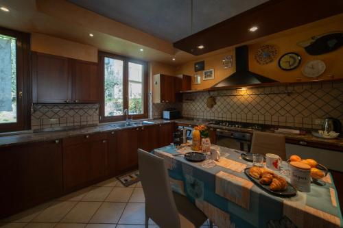 a kitchen with a table with a plate of food on it at Lago di Sole X 6 Point Break in Marone
