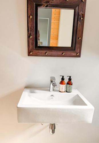 a bathroom sink with a mirror above it at Vrede Villa - no loadshedding in Beaufort West
