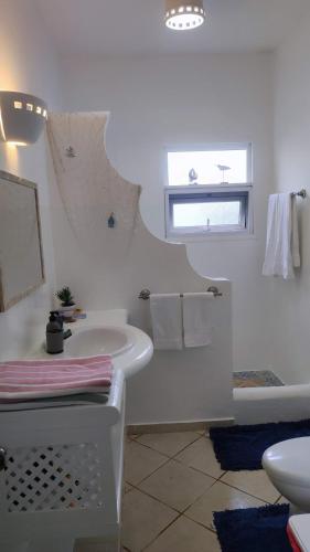 a white bathroom with a sink and a bath tub at Caribe Home Dominicus Oleandra 3 in La Laguna