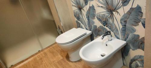 a bathroom with a toilet and a sink at Casa Vacanze Villa Tropia in Camastra ex Solfara